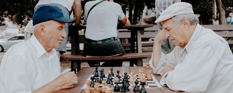 Two senior gentlemen playing chess