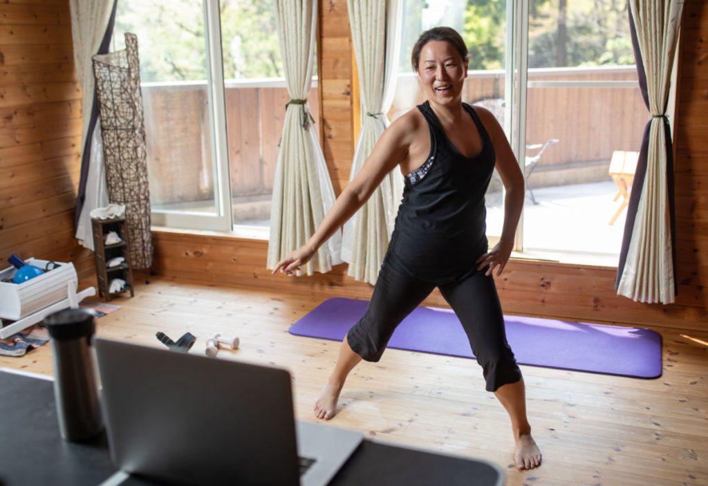 A woman doing aerobic exercises while staying at home