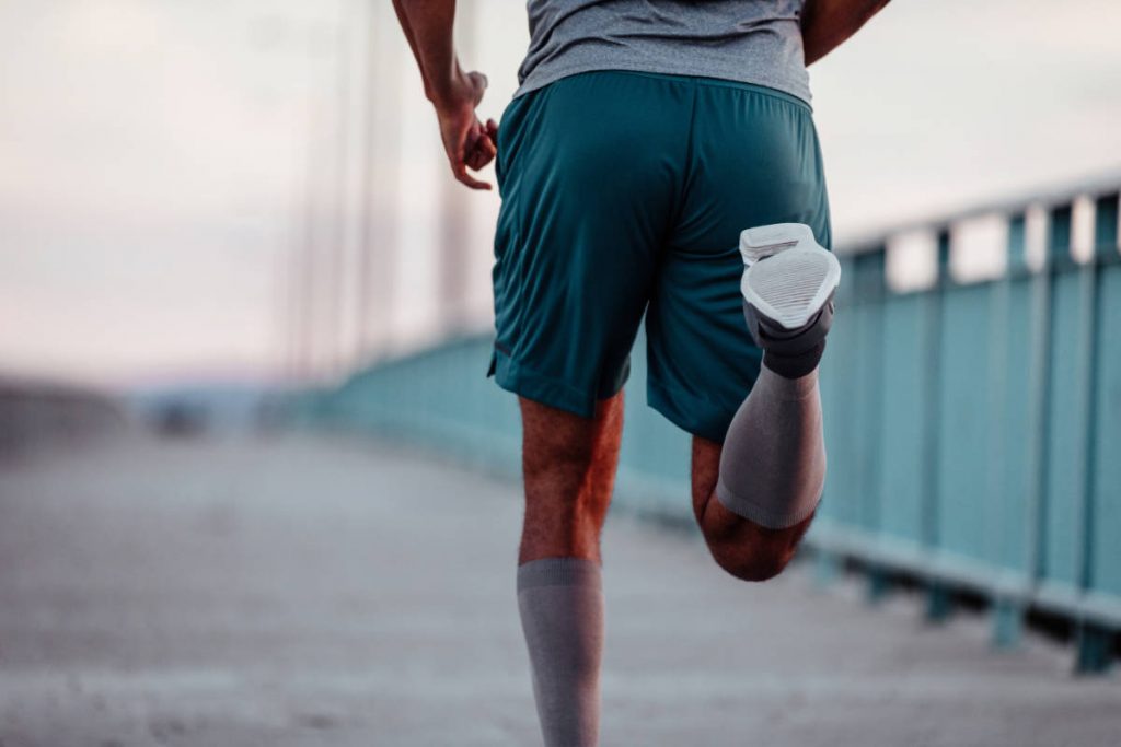 Cropped image of a man running on the bridge